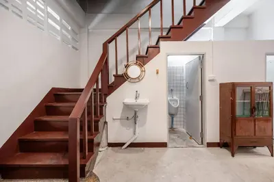 a bathroom with a staircase with a sink and a toilet at Sorrento Bangkok Old Town MRT Samyot in Bangkok