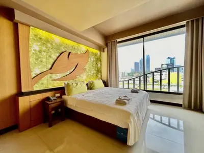 a bedroom with a bed and a large window at Le Ram Hotel No window in Bangkok