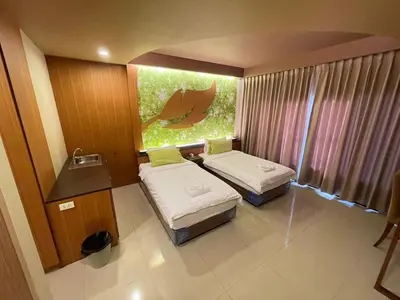 a small room with two beds and a window at Le Ram Hotel No window in Bangkok
