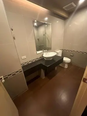 a bathroom with a sink and a toilet and a mirror at Le Ram Hotel No window in Bangkok