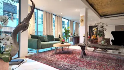 a living room with a couch and a table at Syama Mansion Phromphong in Bangkok