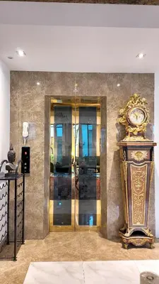 a room with a clock on a wall at Syama Mansion Phromphong in Bangkok