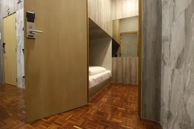 a small room with a bed in a small room at 168 Hostel in Bangkok