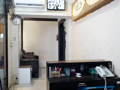 a room with a desk with a phone in it at White House Asoke Sukhumvit 18 in Bangkok