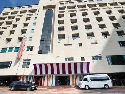 a white van parked in front of a building at Hip Hotel Bangkok in Bangkok