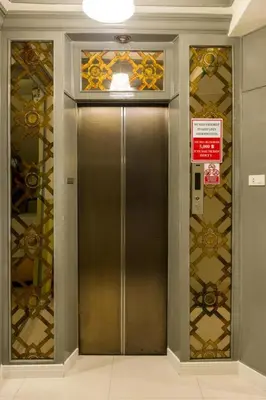 a elevator with a metal door in a building at Prince House in Bangkok
