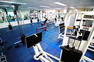 a gym with several treadmills and machines at AC Sport Village in Bangkok