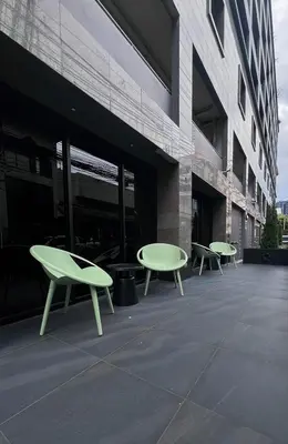 three green benches sitting outside of a building at We Resident in Ban Bang Toei (1)
