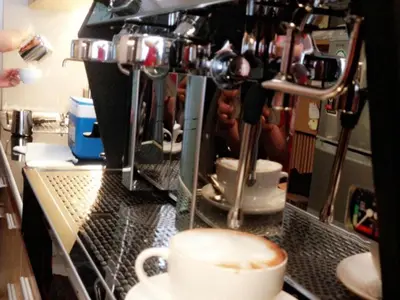 a coffeeacist is making a cup of coffee at Cozy At 9 Hotel And Kitchen in Bangkok