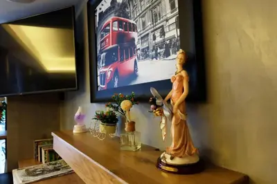 a statue sitting on a shelf in a living room at Cozy At 9 Hotel And Kitchen in Bangkok