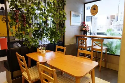 a restaurant with tables and chairs and plants on the wall at Cozy At 9 Hotel And Kitchen in Bangkok