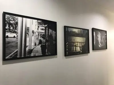 three framed photographs are hanging on a wall at Manoo House E in Pratunam