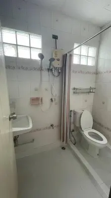 a bathroom with a shower and a toilet and a sink at Manoo House E in Pratunam