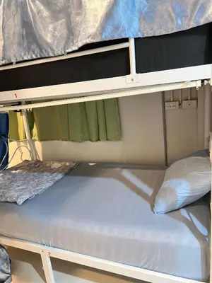 an upper bunk of a bunk bed in a room at Lemon Tree Hostel Khaosan in Bangkok