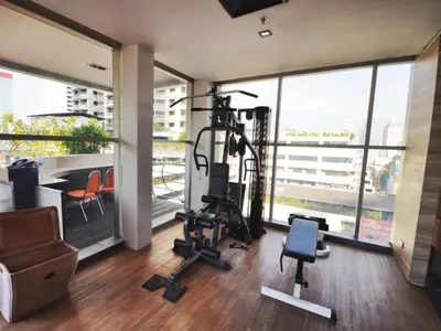 a room with a gym with a large window at The Heritage Silom Hotel in Bangkok