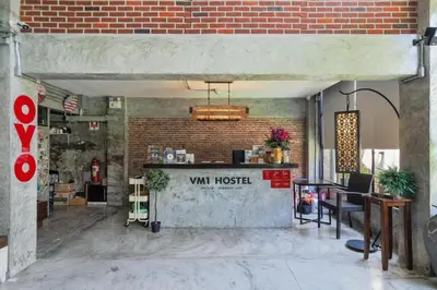 a restaurant with a counter and a brick wall at Vm1 Hostel in Bangkok