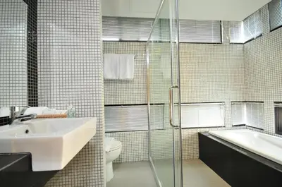 a bathroom with a sink and a toilet and a shower at OYO 225 Premier Place Bangkok in Bangkok