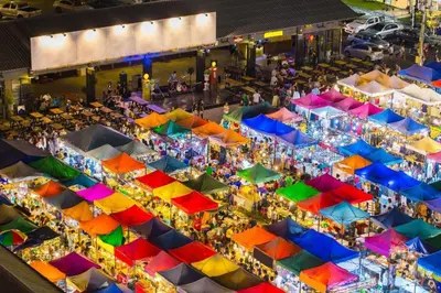 an overhead view of a market with colorful umbrellas at Rest@Ratchada hotel in Bangkok