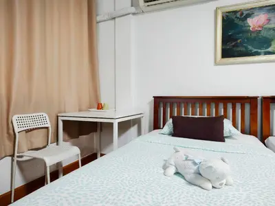 a bedroom with a bed with a stuffed animal on it at Maya Suite in Pratunam