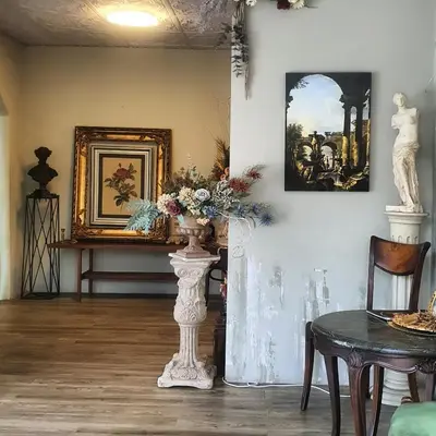 a room with a table and a vase with flowers at Style Jaritz in Ban Bang Phai