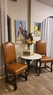 a room with a table with two chairs and a laptop on it at Style Jaritz in Ban Bang Phai
