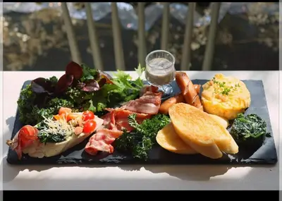a plate of food with meat and vegetables and bread at Style Jaritz in Ban Bang Phai