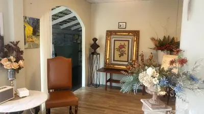a living room with a table and a mirror at Style Jaritz in Ban Bang Phai