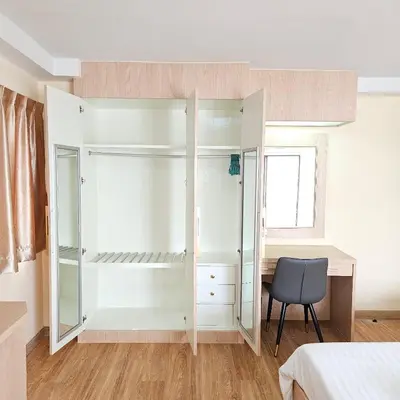 a bedroom with a white closet and a desk at Omni Suites 1Bed #702A in Bangkok
