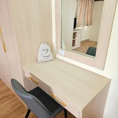 a dressing table with a mirror and a chair at Omni Suites 1Bed #702A in Bangkok