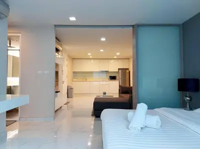 a bedroom with a bed and a living room at Condominium - Sukhumvit Soi 5 BTS Nana- Room Size 47m2 in Bangkok
