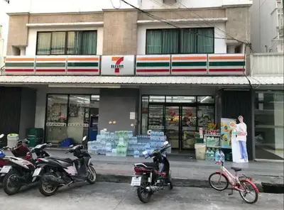 a woman standing in front of a store with motorcycles at Condominium - Sukhumvit Soi 5 BTS Nana- Room Size 47m2 in Bangkok