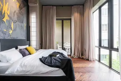 a bedroom with a large bed and a large window at Luxury Pool Villa with Jacuzzi & Lift by Thonglor in Bangkok