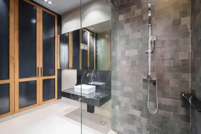a bathroom with a glass shower with a sink at Luxury Pool Villa with Jacuzzi & Lift by Thonglor in Bangkok