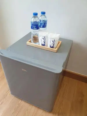 two bottles of water sitting on top of a table at Blue Da Bed บลูด้าเบด in Ban Khlong Khwang Klang