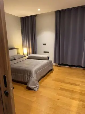 a bedroom with two beds and a wooden floor at \u4e94\u5367\u5ba4\u6e38\u6cf3\u6c60\u522b\u5885 5 Bedrooms Pool Villa in Ban Bang Toei (1)