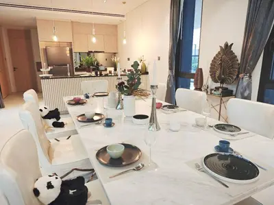 a dining room table with white chairs and a table set with dishes at \u4e94\u5367\u5ba4\u6e38\u6cf3\u6c60\u522b\u5885 5 Bedrooms Pool Villa in Ban Bang Toei (1)