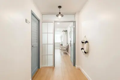 a hallway with a door leading to a dressing room at Lee's Mark in Samutprakarn