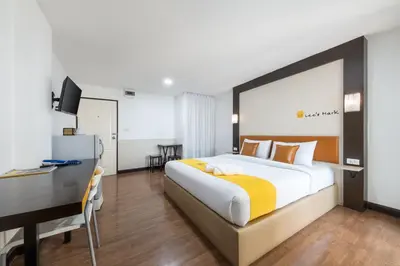 a bedroom with a bed and a desk and a computer at Lee's Mark in Samutprakarn