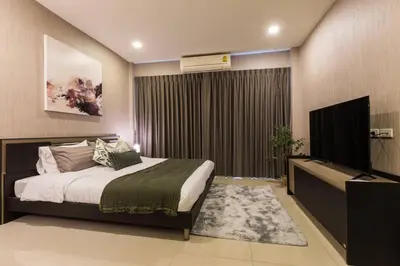 a bedroom with a bed and a flat screen tv at BKK Sukumvit71 1 Bed 2 Bath 1 Living 1 Kitchen in Bangkok