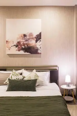 a bedroom with a large bed and a table at BKK Sukumvit71 1 Bed 2 Bath 1 Living 1 Kitchen in Bangkok