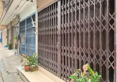a wooden gate on the side of a building at DaHouse next to MRT Itsaraphap exit1 in Bangkok Yai