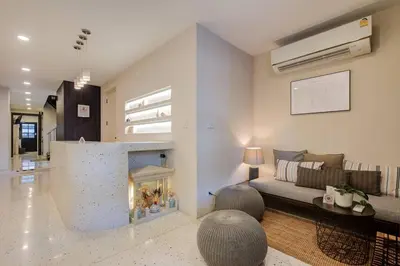 a living room with a couch and a fire place at Potji's private apartment in Bang Su