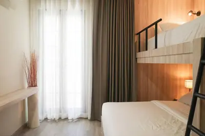 a bedroom with two bunk beds and a window at Potji's private apartment in Bang Su