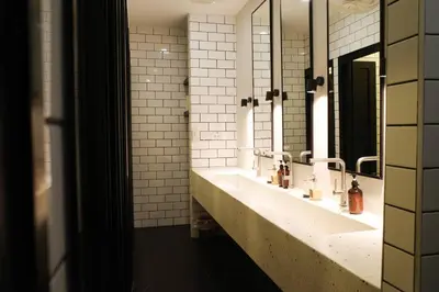 a bathroom with two sinks and two mirrors at Potji's private apartment in Bang Su