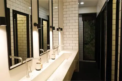 a bathroom with a row of sinks and mirrors at Potji's private apartment in Bang Su
