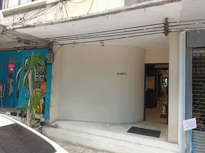 a white wall with the word rip written on it at Potji's private apartment in Bang Su