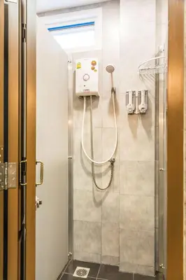a shower in a bathroom with a glass door at Lamoon Vivit in Bangkok