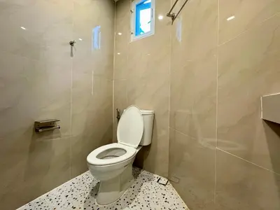 a bathroom with a white toilet and a shower at AVALAN PhayaThai airport link in Pratunam