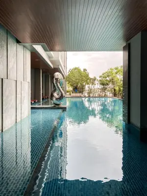 a swimming pool in a building with a pool at Magnificent Apt 1BR - Ultra Fast WiFi - Ekkamai in Bangkok