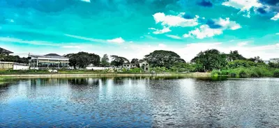a large body of water with houses and trees at Tiny Island Lake Lodge in Bangkok